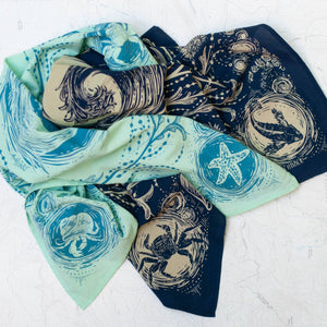 Two patterned bandanas in blue and green on a white background.