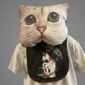 A mannequin wearing a cat mask is modeling a black bib with an astronaut unicorn screenprinted on it.