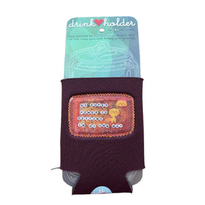 Maroon drink holder with a colorful patch on a wooden surface. The patch says "My super power is getting in my own way."