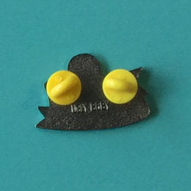 The back of an enamel pin, centered on a solid teal background.