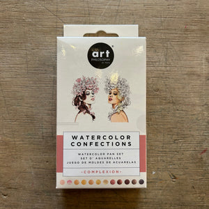 Packaging of Watercolor Confections art set on a wooden surface