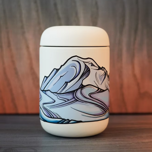 White container with Mount Rainier infinity sticker sitting on a wooden surface.