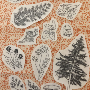 Set of black line art nature-themed embroidery stickers on a patterned background.