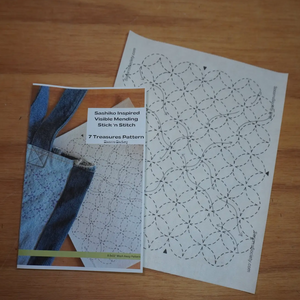 Sashiko inspired visible hemming stitch chart on a wooden surface.