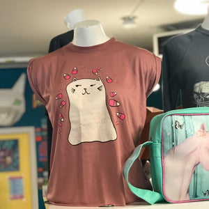 T-shirt with ghost cat design and a unicorn-themed bag on mannequins in a store setting.