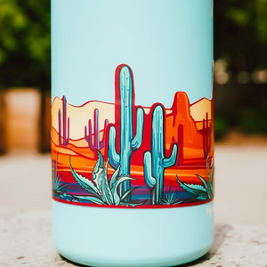 Tumbler with a desert landscape design featuring cacti on a light blue background.