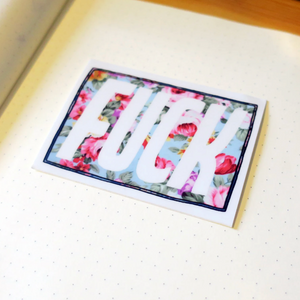 Floral card with the word 'FUCK' on a white, dotted paper.