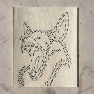 A visible mending guide featuring a design of a bat's head with its mouth open and teeth showing against a marble backdrop.