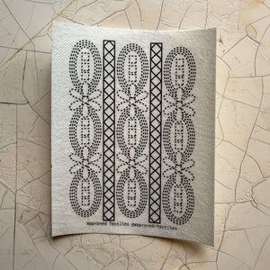 Visible mending guide sticker featuring daisies and ovals in a pattern with diamonds inside of long rectangles.