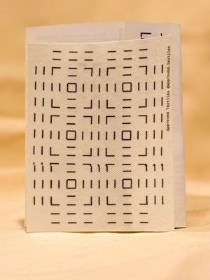 White visible mending guide transfer with black geometric pattern on a beige background