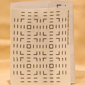 White visible mending guide transfer with black geometric pattern on a beige background