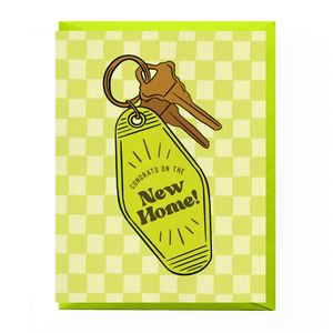 Greeting card with keys and 'Congrats on the New Home!' tag on a green checkered background