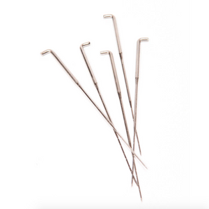 Set of five metal felting needles on a white background.