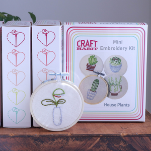 Craft Habit embroidery kit with a mini hoop featuring embroidered house plants on a wooden surface.