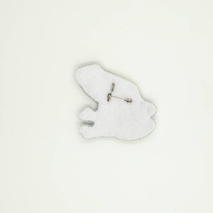 Back of the beaded frog brooch, including white felt shape and silver brooch pin.