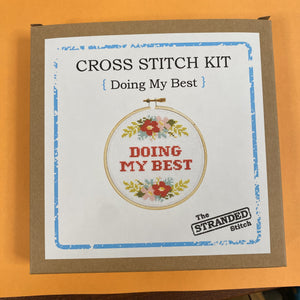 Packaged cross stitch kit by The Stranded Stitch. The design says "Doing My Best" and the text is surrounded by flowers.