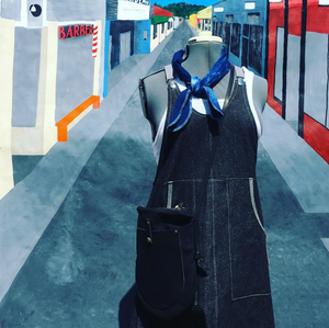 Denim apron with a blue scarf on a stylized city street background