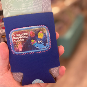 Black neoprene drink holder with a patch on the front that says "Cupcake Storm"