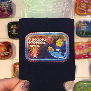 Black neoprene drink holder that says "Cupcake Storm" on a patch on the front.