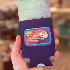 Purple can cooler with a patch on the front that says "You increase my dopamine levels"