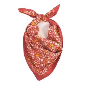 Red patterned bandana tied into a scarf.