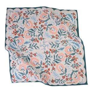 A floral patterned bandana in shades of blue, pink, and red.