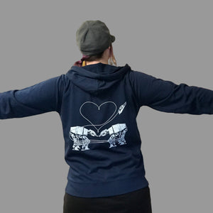 Person wearing a blue hoodie with a the Love AT-AT First Sight design in a store setting.