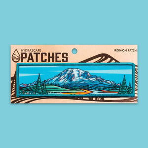 Iron-on patch with mountain design on a blue background