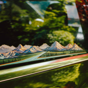 The Cascade Volcanoes infinity sticker displayed on a car's back window.