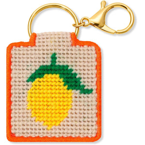 Needlepoint keychain with lemon design on a beige background