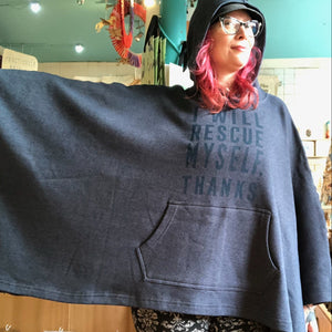 Person wearing a blue hoodie with text that says "I will rescue myself, thanks" in a store setting.