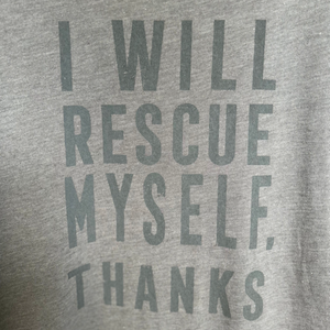 Gray t-shirt with text 'I WILL RESCUE MYSELF, THANKS' on a plain background