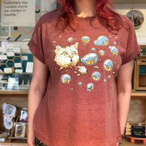 Person wearing a red t-shirt with a cartoon cat design in a store setting