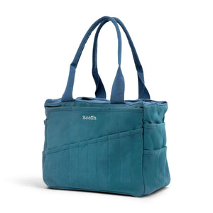 Blue tote bag with multiple pockets and a visible brand logo on a white background