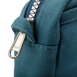 Close-up of a blue fabric bag with a metal zipper, featuring the YKK brand.