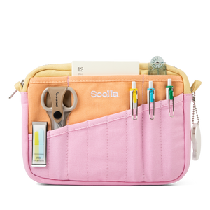Pink pencil case with compartments containing stationery items on a white background