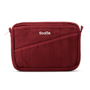 A red fabric pouch with a diagonal front pocket and the brand name 'Soolla' embroidered in white on the front, shown on a clean white background.