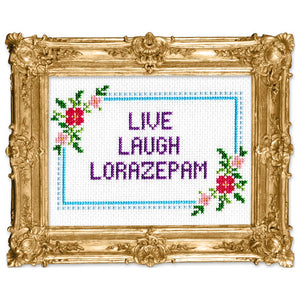Cross stitch pattern in a gold frame that reads "LIVE LAUGH LORAZEPAM" with a floral border.