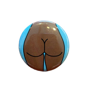 Button badge with a stylized depiction of buttocks