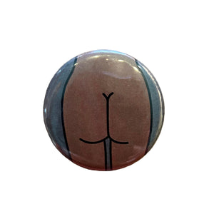 Round button featuring a design of a butt against a dark gray background.