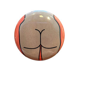 Round button with a stylized butt design on an orange background