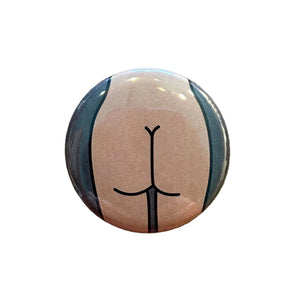 Round magnet with a cartoon illustration of a butt on a white background.