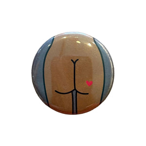 Round magnet with a cartoon illustration of a butt against a white background