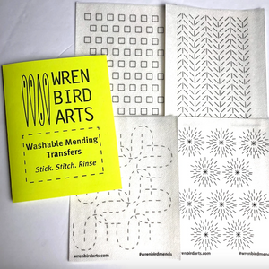 Four variations of washable mending transfers next to their bright yellow packaging with Wren Bird Arts branding
