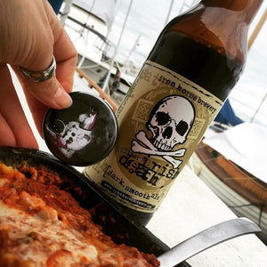 Customer photo of their bottle opener keychain with an Astronaut Unicorn on it. They are drinking a beer called Irish Death and eating some pasta.