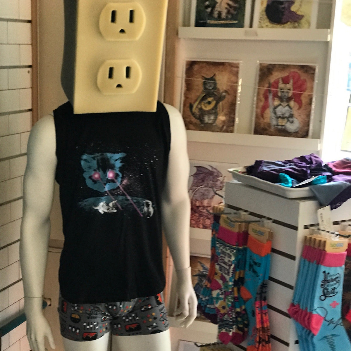Black tank top with Meta Laser Cat design worn by a mannequin with an electrical outlet for a head. 