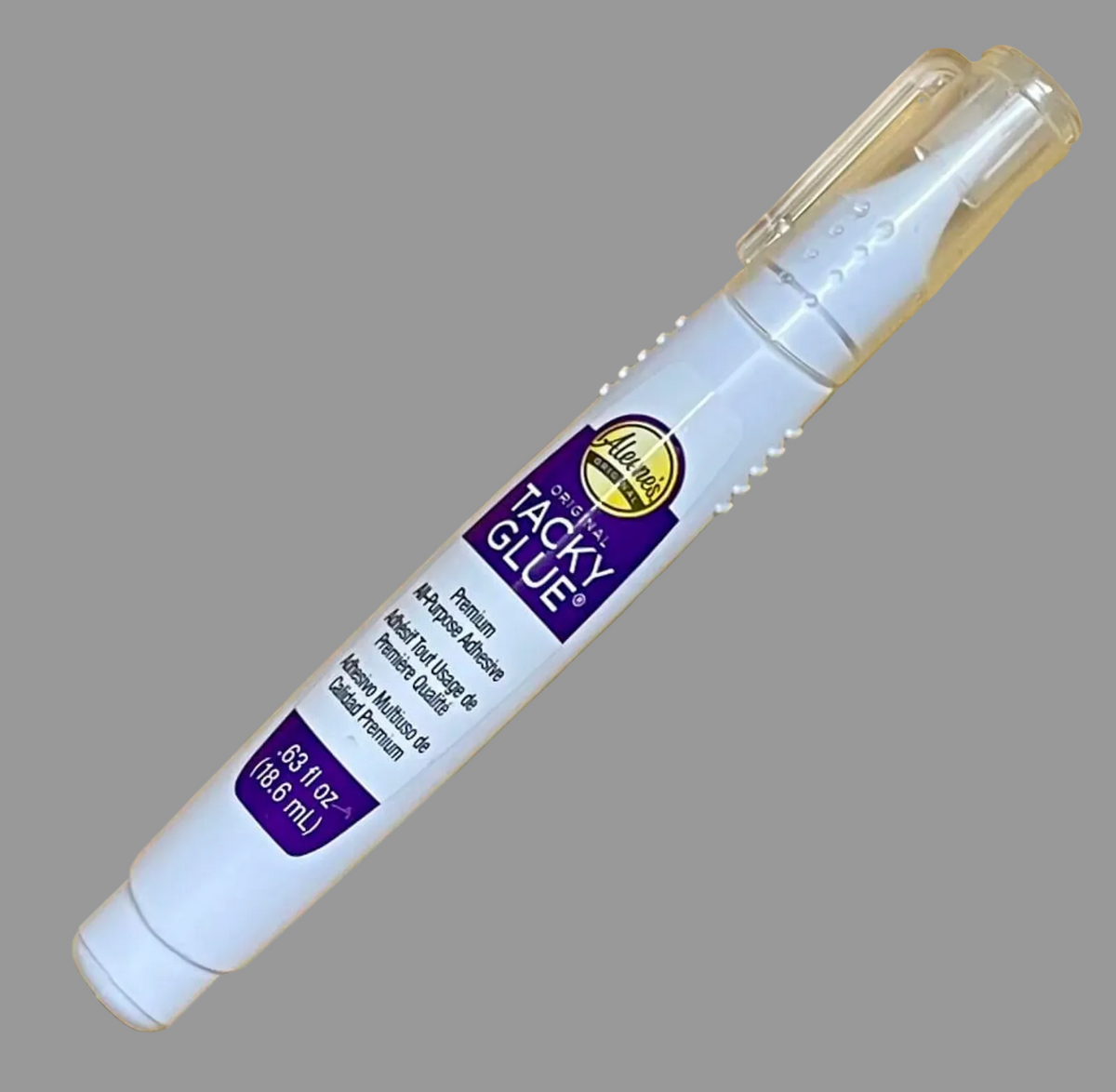 White glue pen with purple label on a gray background. 