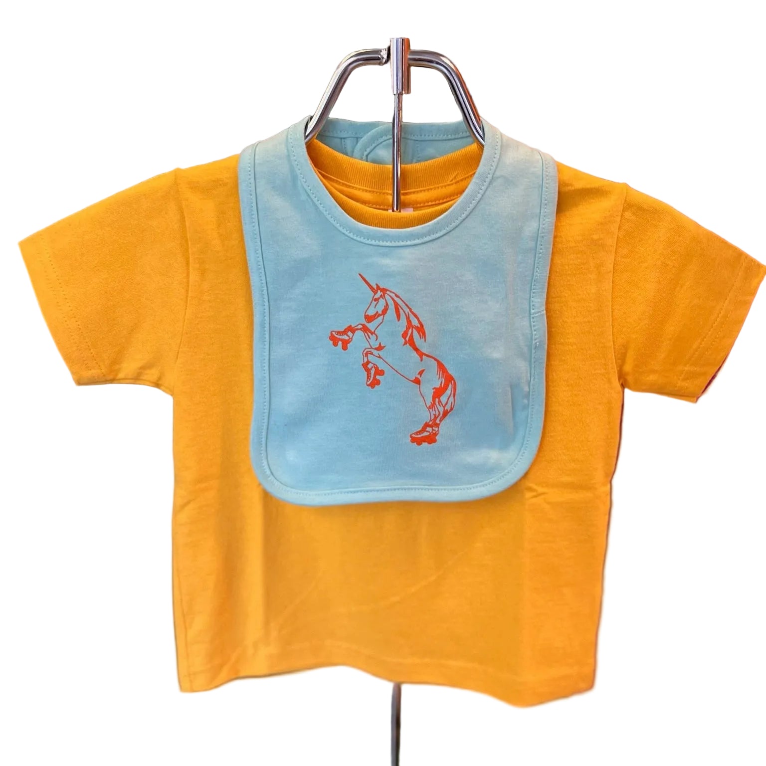 Yellow baby shirt with blue bib featuring an orange unicorn design. 