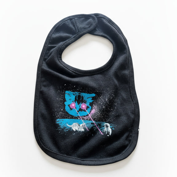 Black bib with space cat theme design featuring a cat in the sky shooting lasers at two kittens. The kittens are playing in the lasers. 