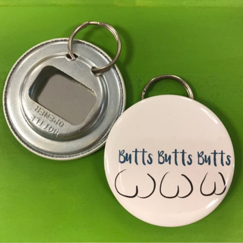 Keychain with bottle opener and 'Butts Butts Butts' text on a green background. 